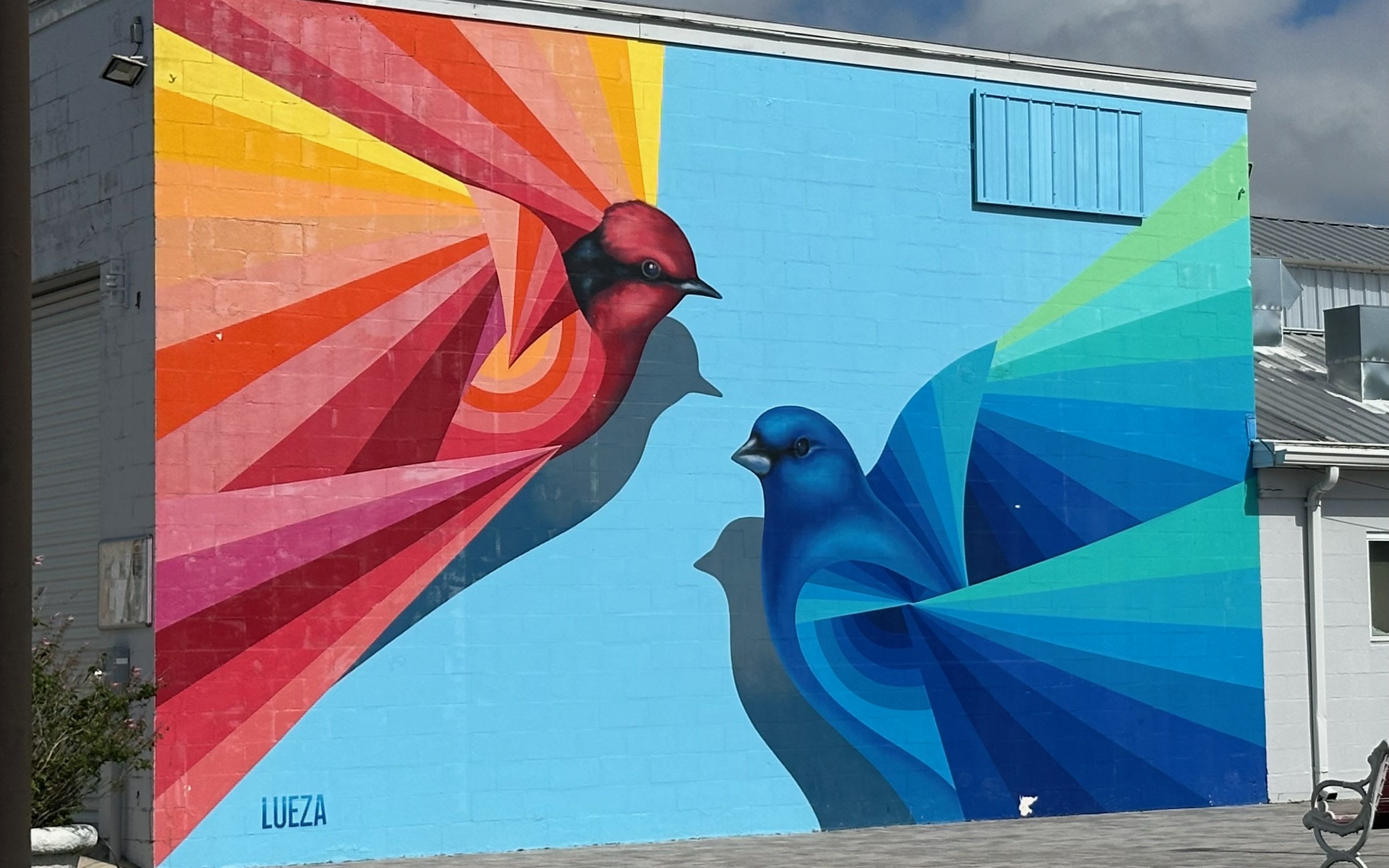 Cecilia Lueza Encounter mural with red and blue birds in the Arts District